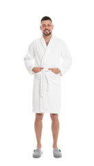 Handsome man wearing bathrobe on white background