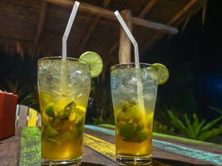 Two glasses of refreshing Mojito cocktails with ice and lime