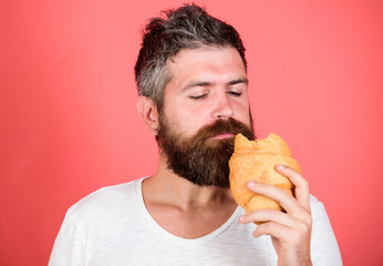 hungry hipster bite croissant. Delicious breakfast. Unhealthy but yummy breakfast. Perfect match. feel hunger. Bearded hipster enjoy breakfast. Morning tradition concept. Fresh baked croissant