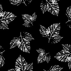 White leaves prints on a black background. Seamless black and white pattern for wallpaper, wrapping paper, textile, and web design. Monochrome botanical texture