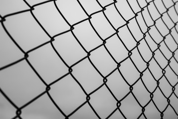 Abstract image of selective focus at iron fence with sky in black and white tone.