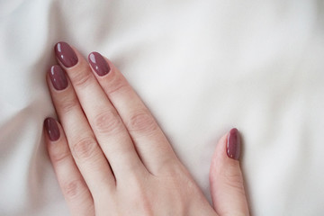 Violet manicure and pink silk.