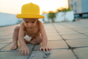 Adorable baby boy playing outdoor sunset light