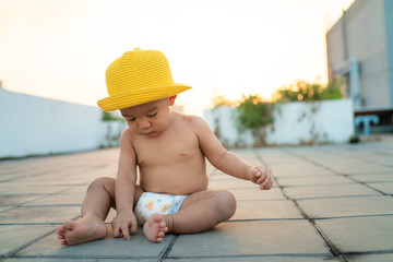 Adorable baby boy playing outdoor sunset light