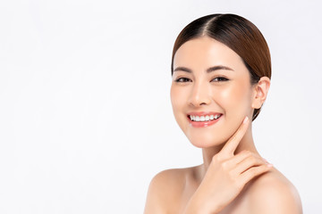 Youthful bright skin smiling pretty Asian woman with hand touching face