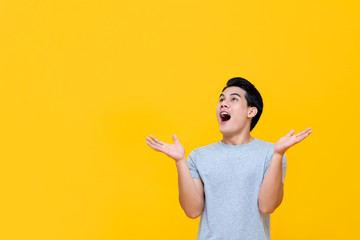 Excited Asian man gasping with hands open