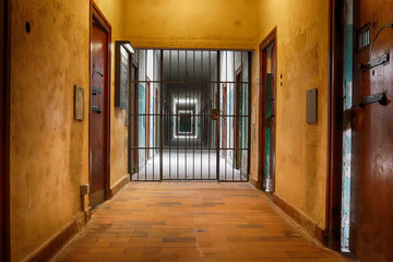 Prison corridor with grating oppressive