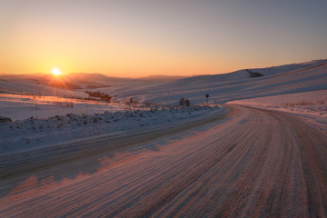 Fototapeta na wymiar road snow mountains winter pass sunset sun