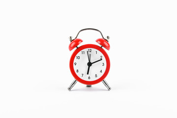 Red retro alarm clock on a white background. Round red alarm clock on a white background isolated. standard timer concept, warning of a change in time, retro signal of the beginning of the work of the