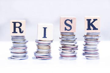 Risk text stacked upward on coins , High Risk Business Concept..
