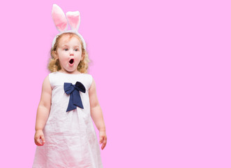Lovely blonde toddler wearing easter bunny ears