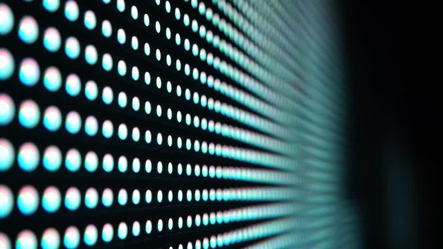 Multicolored glowing RGB dots diode blinking disco lights. RGB multicolored dots led light panel at the night club, led light wall VJ background.