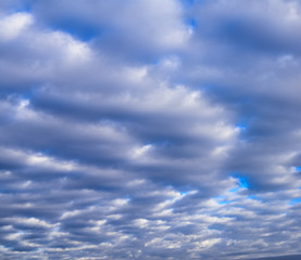 Beautiful puffy pastel colored clouds against blue skies.