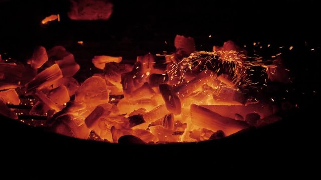 A grill filmed in slowmotion by night.