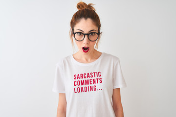 Fototapeta premium Redhead woman wearing funny t-shirt with irony comments over isolated white background scared in shock with a surprise face, afraid and excited with fear expression