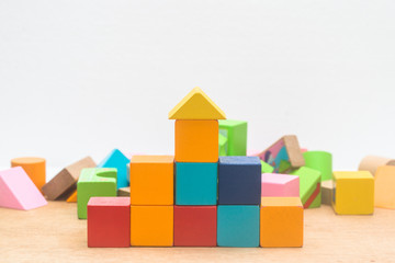 Wooden blocks built on wooden boards and faded brick backgrounds