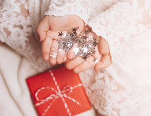 Silver stars sparkling on child's hands and palms.