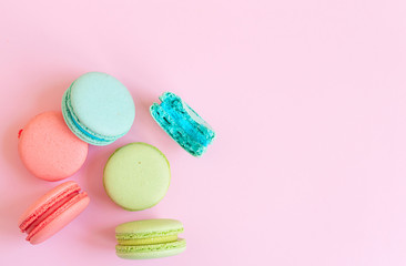 colorful macaroons on pink background