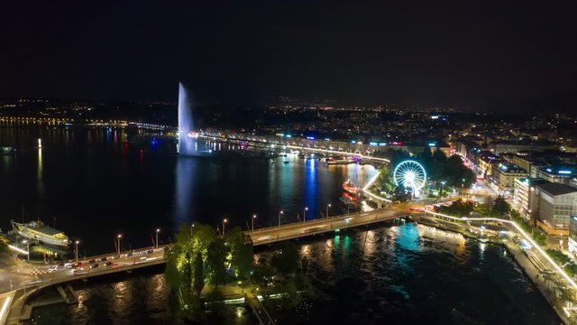 night illumination flight over geneva city lake traffic bridge fountain aerial panorama 4k timelapse switzerland