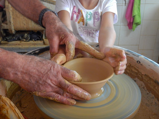 Top view of a electrically rotating potter's wheel, stacked mud on it to make potter products.