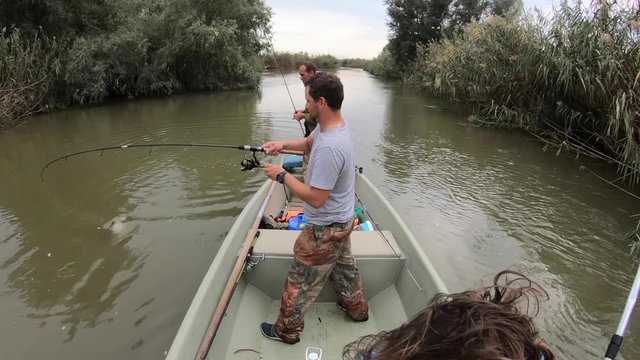 Amateur angler fights with the asp fish (Leuciscus aspius) and finaly catches it with the help of his friend