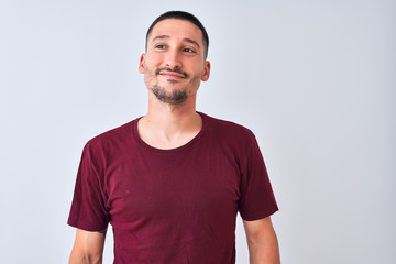 Young handsome man standing over isolated background smiling looking to the side and staring away thinking.