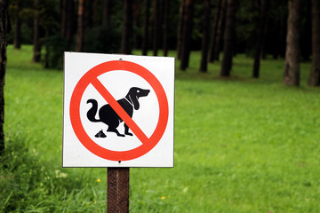 No Dog Poop Sign on the post