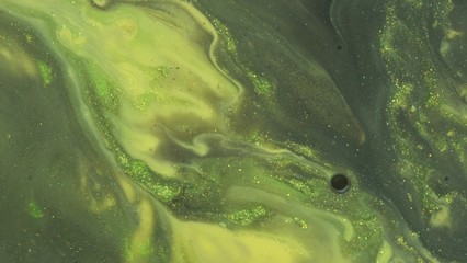 Yellow green olive gold black glitter acrylic paint flowing. Liquid sparkle texture. Shiny...