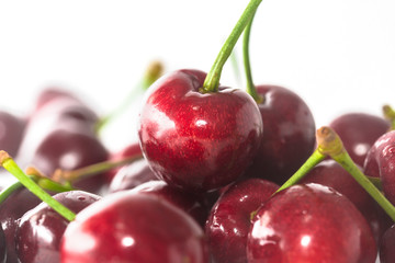 A few fresh cherries on a white background