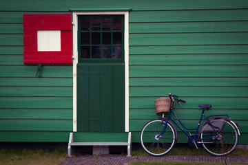 Fototapeta na wymiar Bicycle standing near the green house