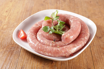 raw sausage and herb on wood background