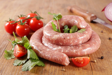 raw sausage and herb on wood background