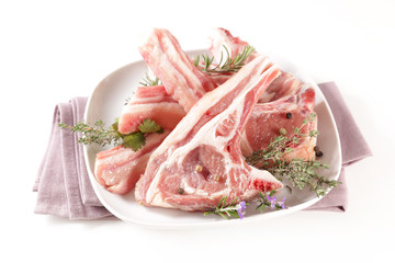 raw lamb chop and rosemary on wood background