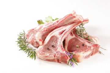 raw lamb chop and rosemary on wood background