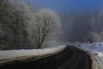 Misty morning among beautiful winter mountains