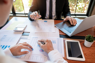 teamwork company meeting concept, business partners working with laptop computer together analysing startup financial project result or strategy plan and discussing data document in office.