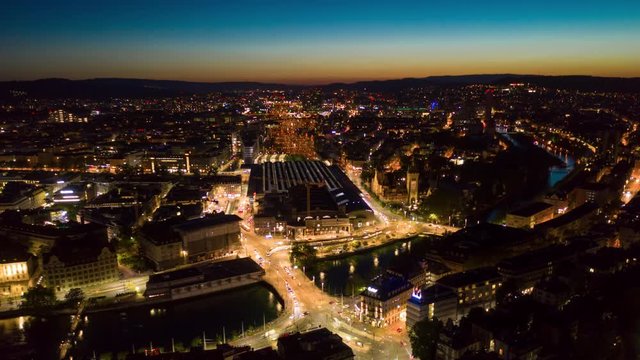 sunset night illuminated zurich city lakeside and traffic train station square aerial panorama 4k timelapse switzerland 