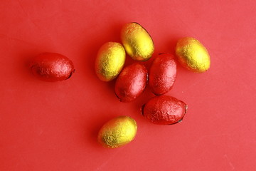 chocolate easter eggs, wrapped in yellow and red paper