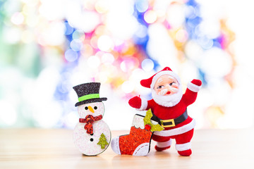 Happy Christmas idea background, Santa with snowman and red sock over blurred colorful bokeh background, Festive season and holiday concept background