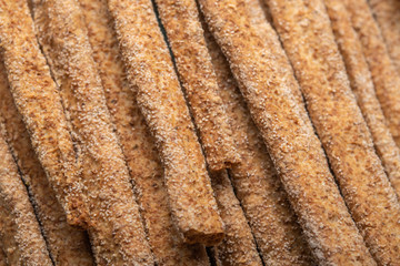 Background from Italian traditional rye bread grissini. Selective focus