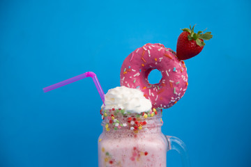 Delicious dessert strawberry smoothie with pink bagel and cream