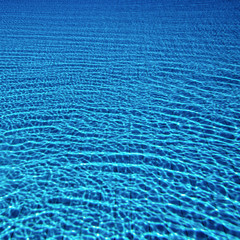 Solar highlights from the surface of the water are reflected at the bottom of the pool.