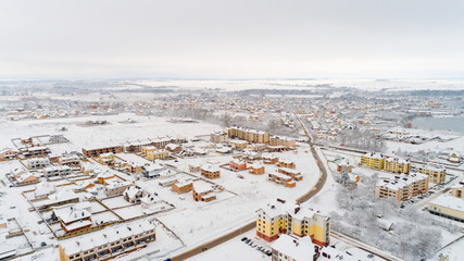 Top view of the winter village with snow covered houses and roads. Aerial view of landscape