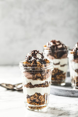 Yogurt parfait with granola, chocolate and ice cream. Sweet delicious breakfast