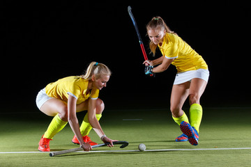 Field hockey girl player performing penalty stroke