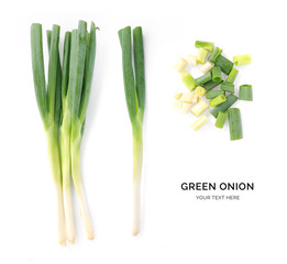 Creative layout made of green onion. Flat lay. Food concept. Green onion on white background.