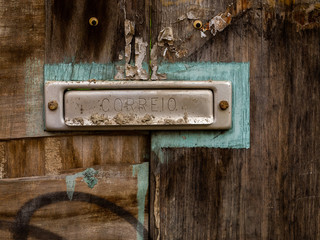 Vintage metallic mailbox on a wood grunge door