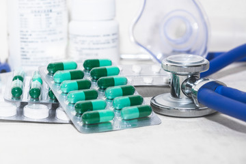Fototapeta premium Stethoscopes on the table, empty capsules, medicines, bottles and medical supplies