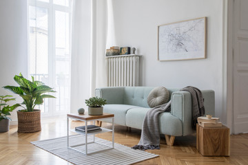 Stylish scandinavian living room with design mint sofa, furnitures, mock up poster map, plants and...