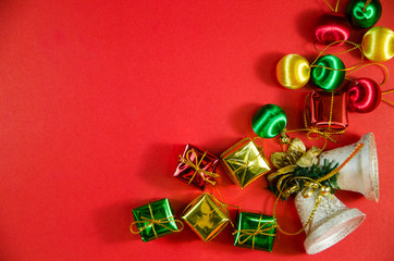 group of bell, ball and gift in christmas on red background on top view